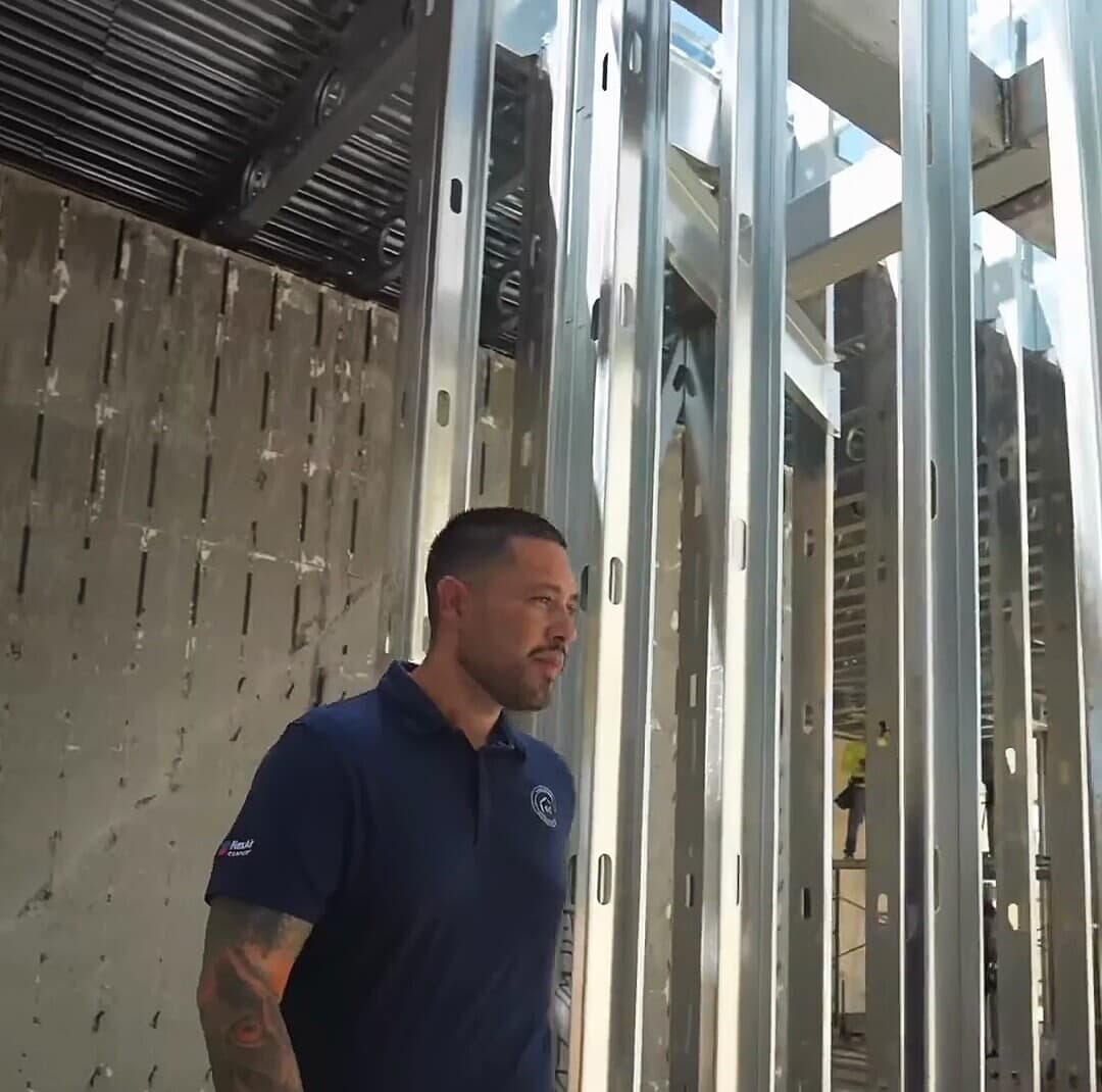 A Saddlewood team lead standing in the structural framing of the active Paradise Valley build
