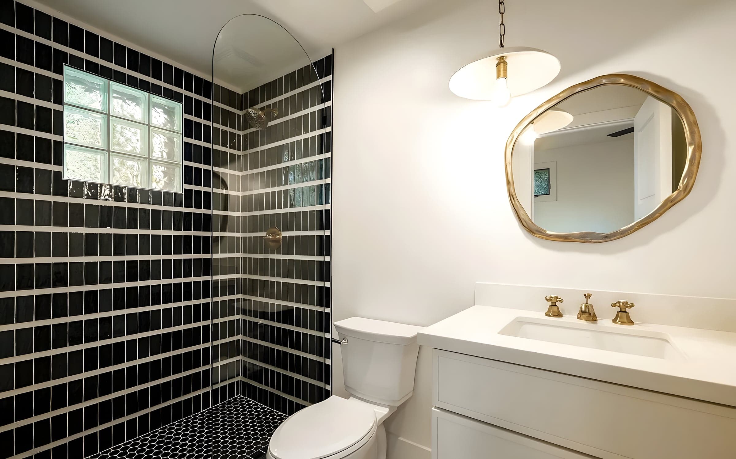 Floor-to-ceiling stone tile and frameless glass create a seamless, spa-like shower experience.
