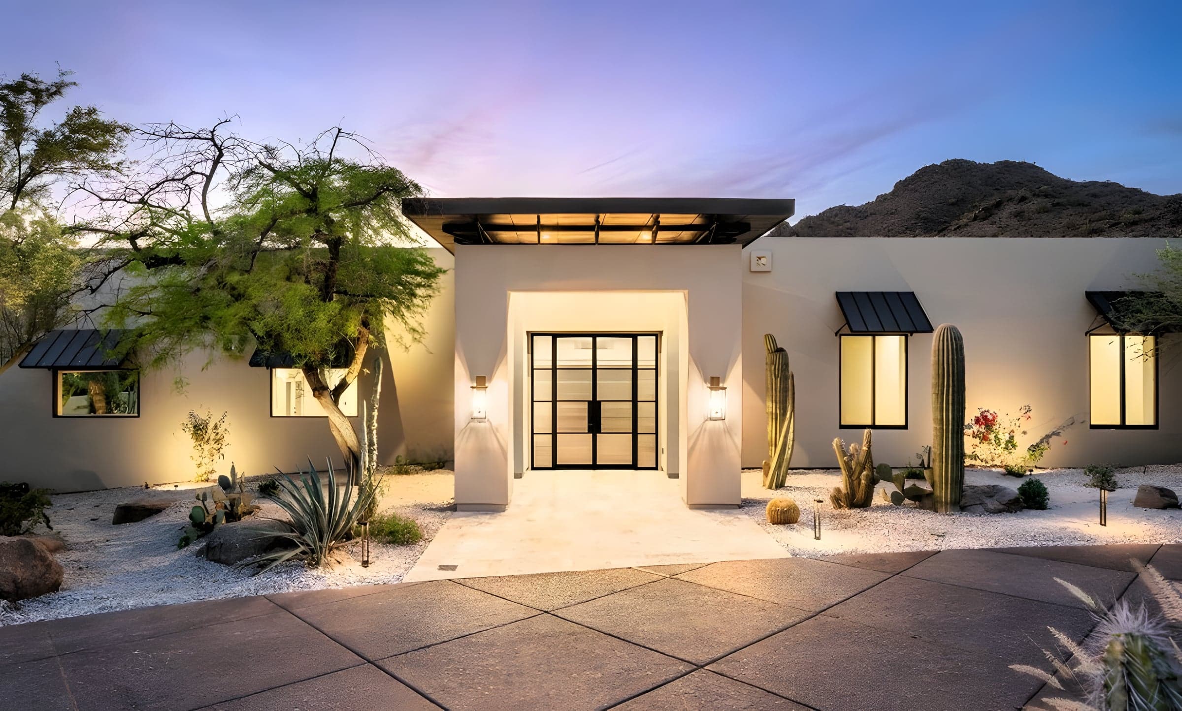 Custom home front entrance at dusk, designed and built by Saddlewood Contracting