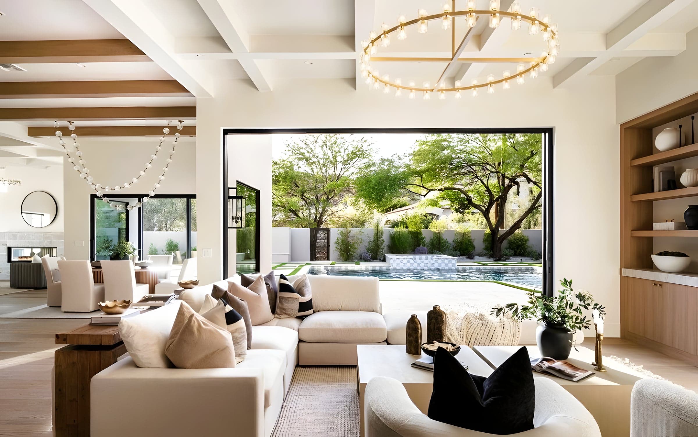 The boundary between great room and pool dissolves — a single architectural gesture connects living space to landscape.