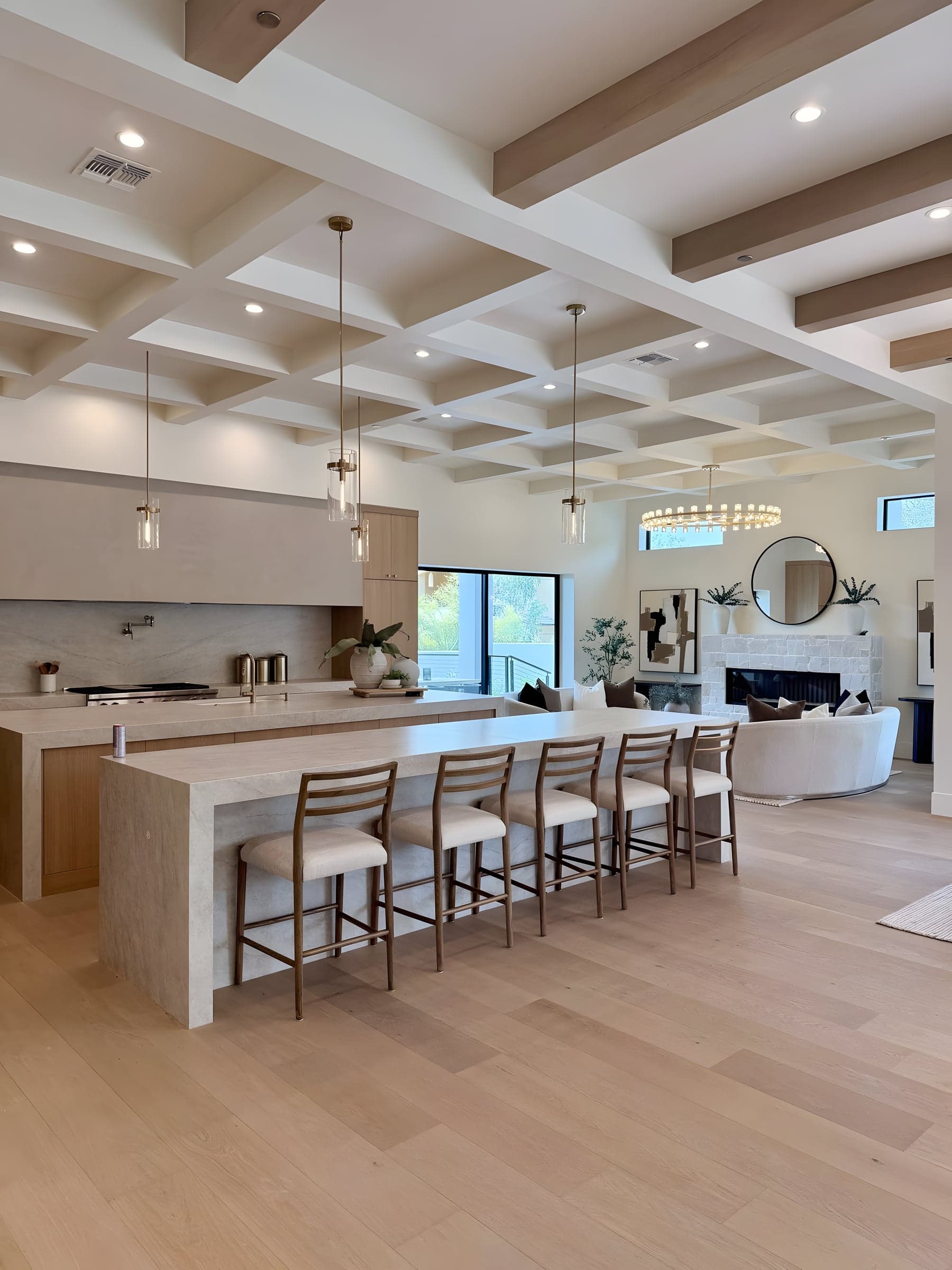 Finished chef's kitchen with natural stone island and coffered ceiling