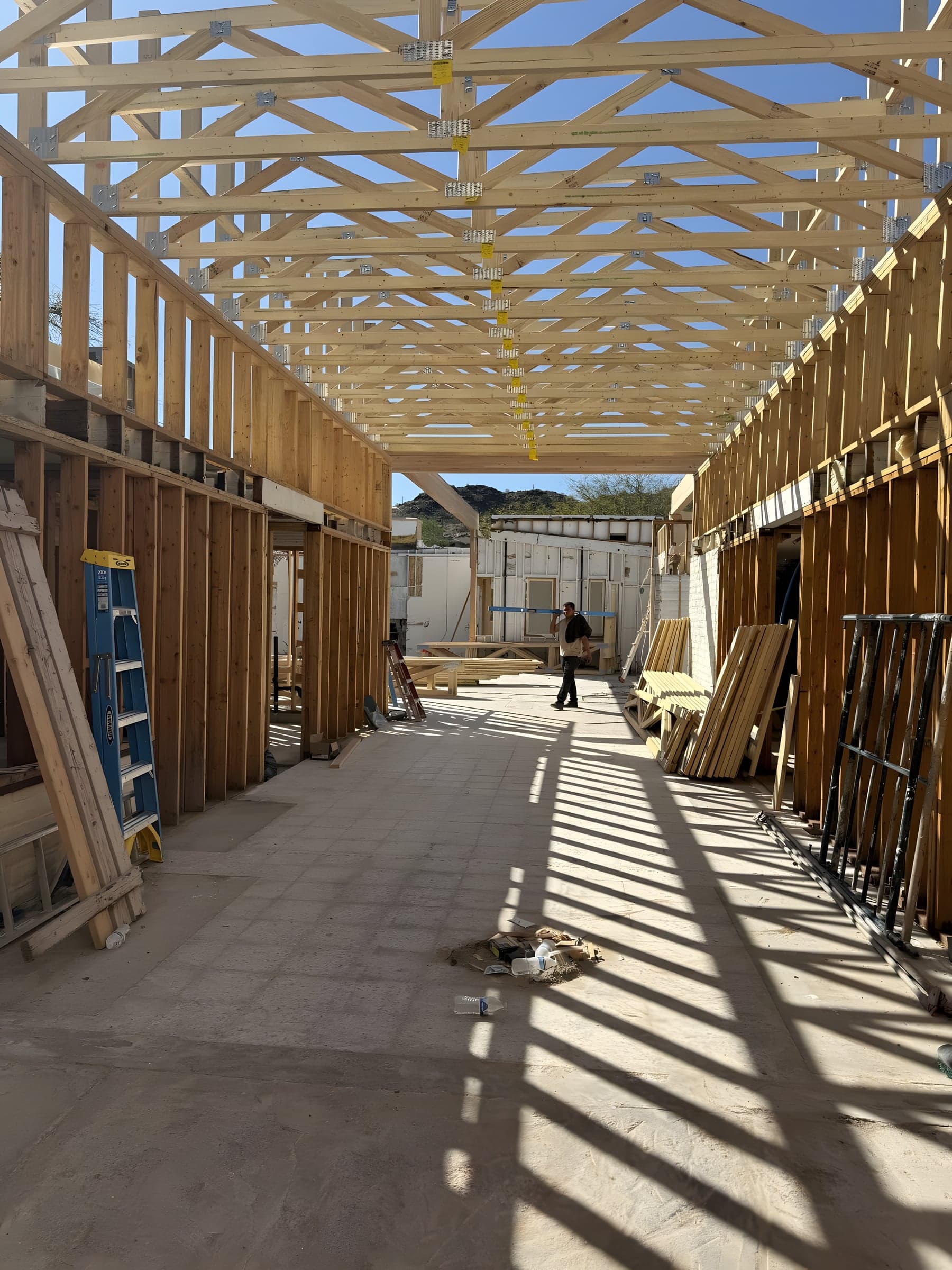 Framing crew members working on top of structural framing