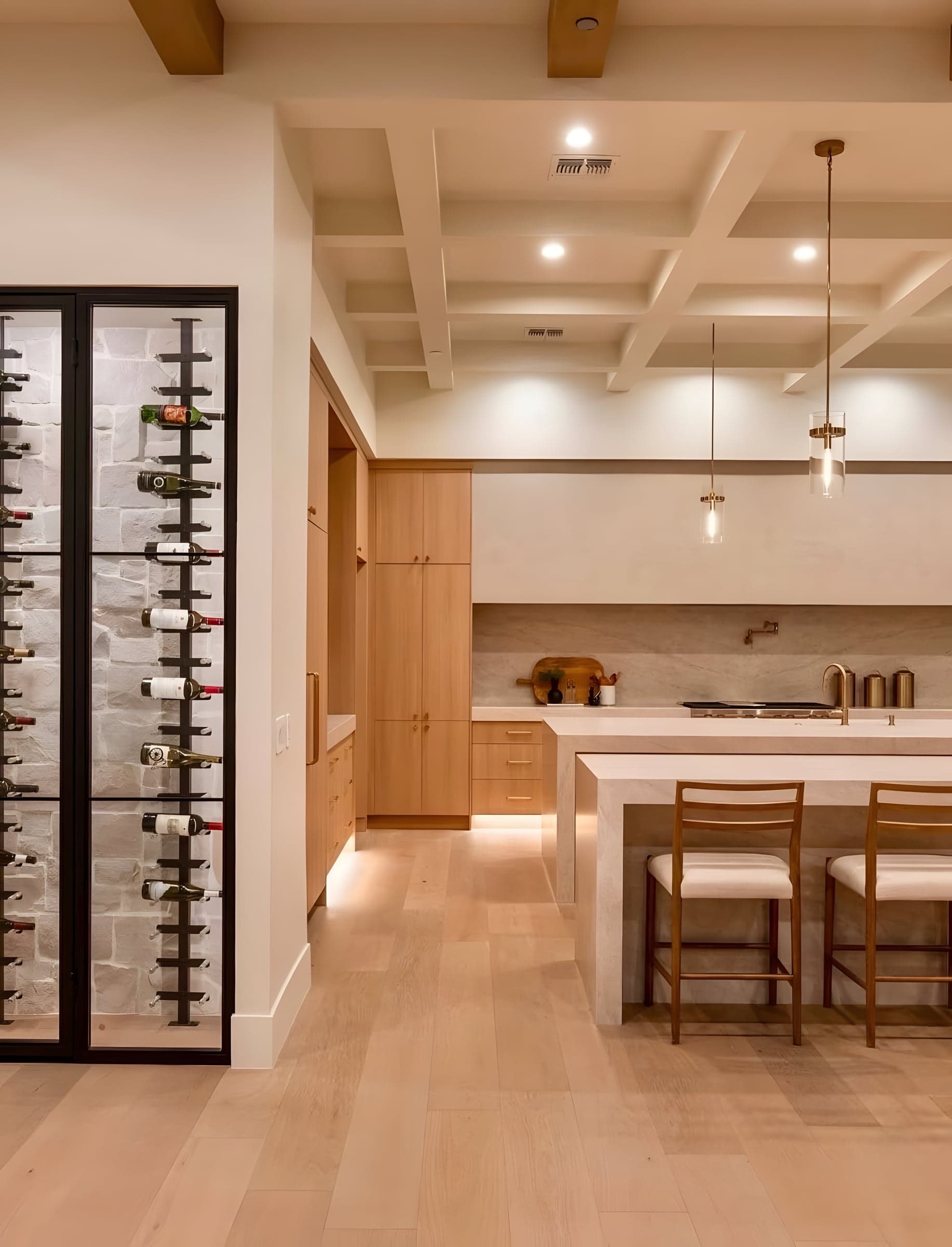 The wine wall meets the kitchen island at the heart of the home — designed for hosts who love to cook and entertain simultaneously.