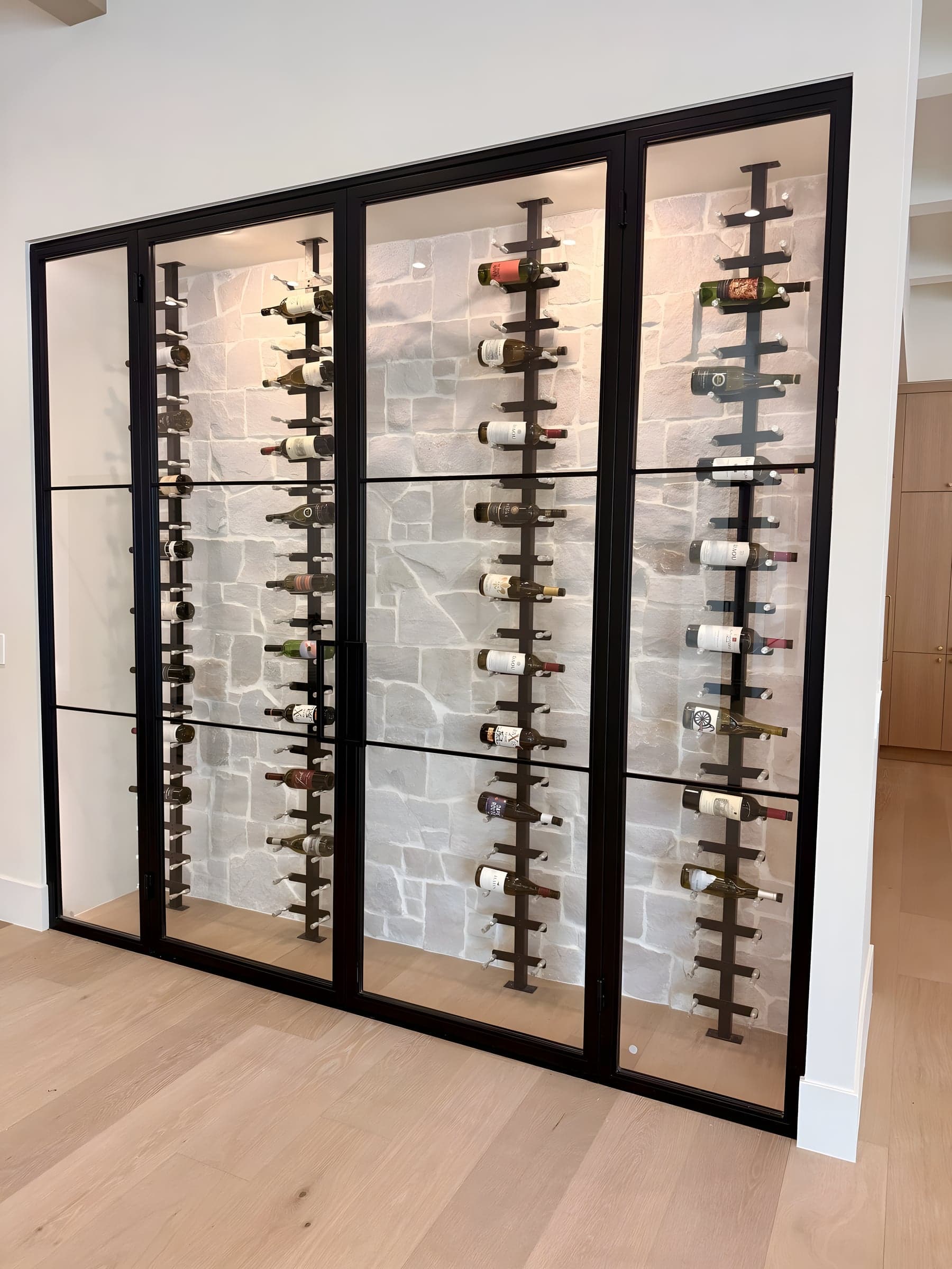 Paradise Valley climate-controlled glass wine wall with stone backing